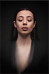 portrait young elegant woman with closed eyes wearind black jacket. Fashion studio shot. Motion effect