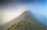 mountain peak in dense fog, Alps