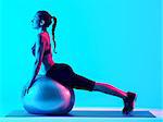 one mixed races woman exercsing fitness pilates exercices isolated on blue blackground