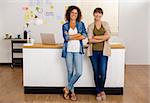 Two happy businesswoman working together in an office