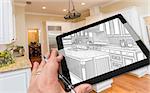Hand of Architect on Computer Tablet Showing Drawing of Kitchen Photo Behind.