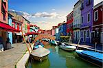 Bright colorful houses and water street in Burano, Italy