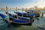 Venetian gondolas on Canal Grande in Venice at sunset, Italy