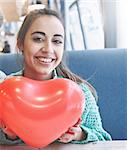 woman with balloon in the form of heart in a cafe. Couple in love on a date. Love story and Valentines Day concept