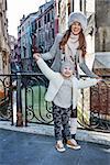 Venice. Off the Beaten Path. Full length portrait of smiling modern mother and daughter tourists in Venice, Italy in the winter having fun time