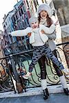 Venice. Off the Beaten Path. Full length portrait of smiling young mother and daughter tourists in Venice, Italy in the winter having fun time