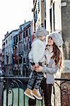 Venice. Off the Beaten Path. happy modern mother and daughter tourists in Venice, Italy in the winter looking at each other