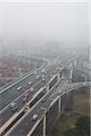Elevated roadways meet in the mist, Changning Qu, Shanghai, China