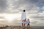 Woman and young boy looking out to sea.