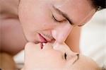 Young couple kissing on bed