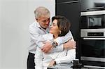 Mature man with arms around wife