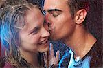 Young couple kissing in the rain