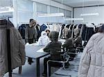 Product developers inspecting coat