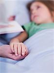 ill young girl lying in bed