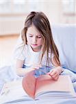 young girl sitting in bed