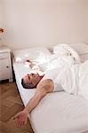 man lying on bed relaxing