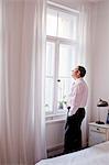 man standing in front of window