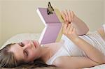 butterfly resting on teenage girls book