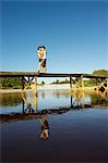 Teenage couple kissing on jetty