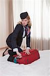stewardess on hotel bed, closing trolley