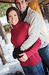 Couple in winter clothes hugging