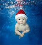 Female baby underwater with hat