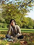 Woman under tree listening to music