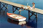 Teenage girls relaxing on jetty