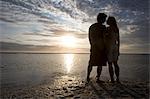 Couple kissing at sunset on the beach