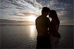 Couple kissing at sunset on the beach