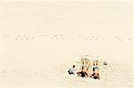 Two girls sunbathing on sandy beach