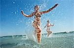 Two girls splashing in the sea