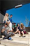 Group of young people sitting on steps