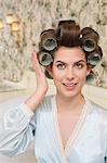 young woman checking her curlers