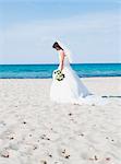 bride on beach holding bridal bouquet