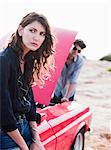 couple standing at car with opened hood