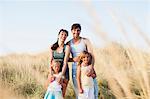 family smiling at the beach