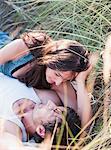 couple lying in grass smiling