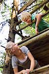 boy and girl climbing tree house