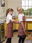 A girl helping to put on an apron