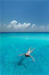 Woman floating in tropical sea