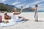 Boy shooting grandmother with toy arrow