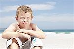 Boy sitting on beach