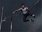 Man jumping midair in pole vault