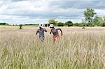 Men running in wheat field