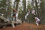 Dancers jumping in forest