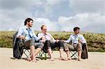 Businessmen relaxing on beach