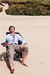 Businessman relaxing on beach