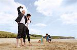 Businessmen building sand castle