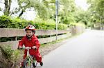 Smiling boy riding bicycle outdoors